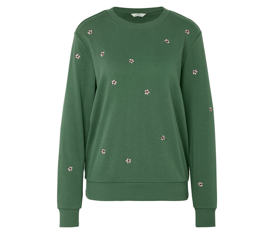 Un sweat-shirt vert avec de petites broderies florales.