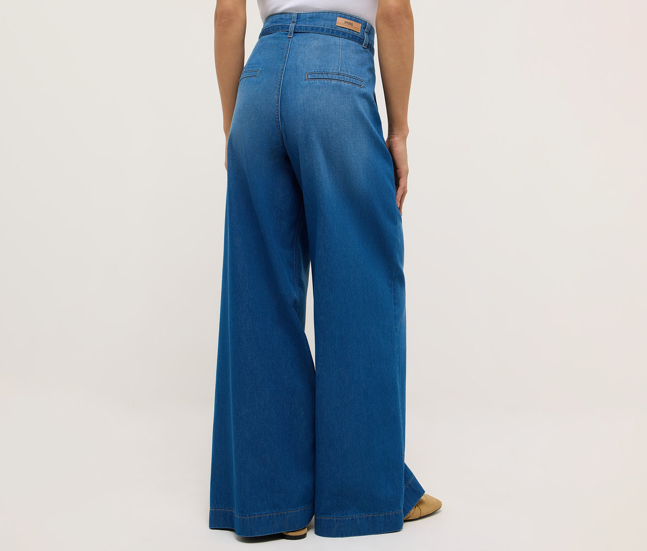 Vue arrière d'une femme portant un jean Angels Denim « Liva » Sleek Wide Leg et des chaussures plates.