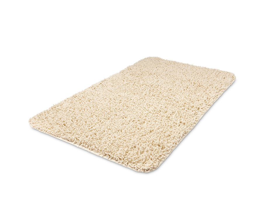 Un tapis de bain vanille, recyclé, d'environ 70 x 120 cm.