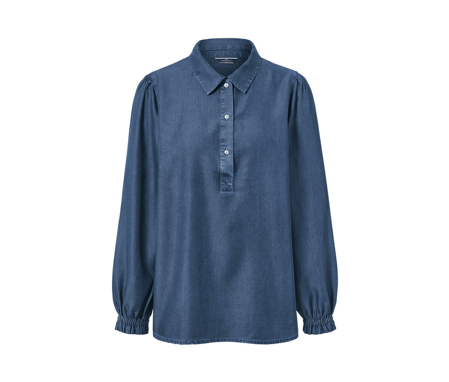 Blouse en jean bleue avec manches bouffantes.