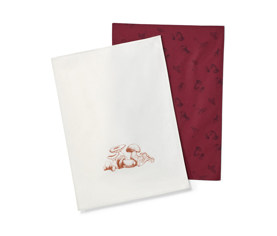 Deux linges de cuisine : un blanc avec un imprimé de champignons marron et un bordeaux avec un imprimé de champignons plus foncé.