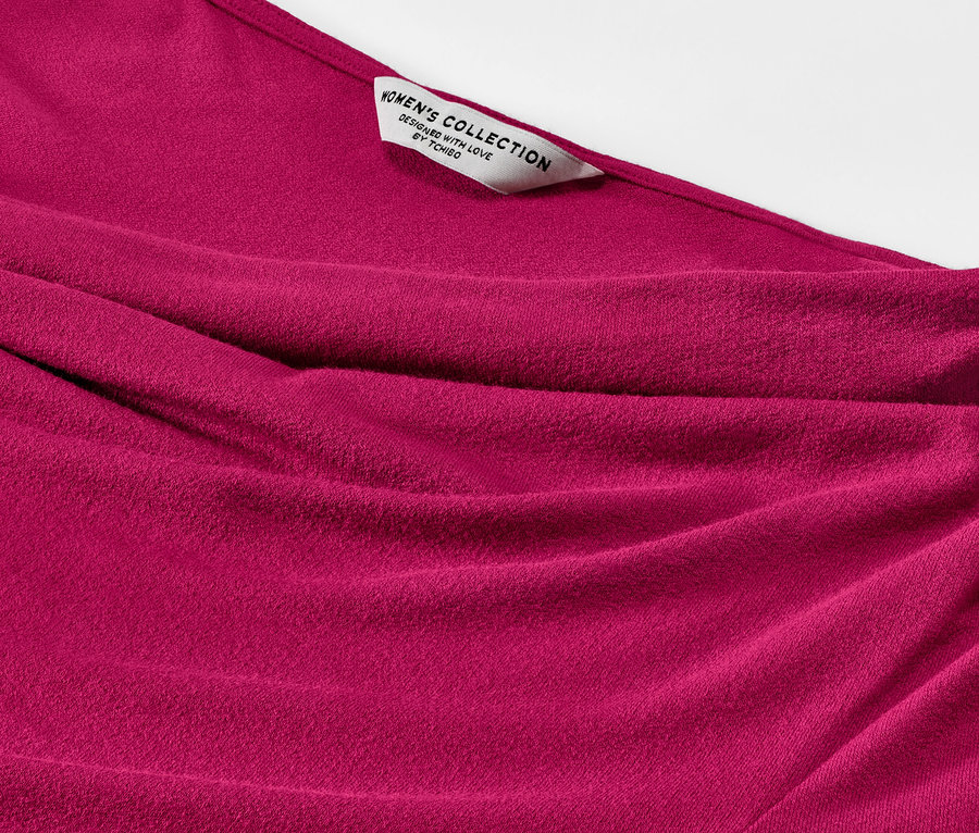 Gros plan sur une blouse avec encolure en cascade.