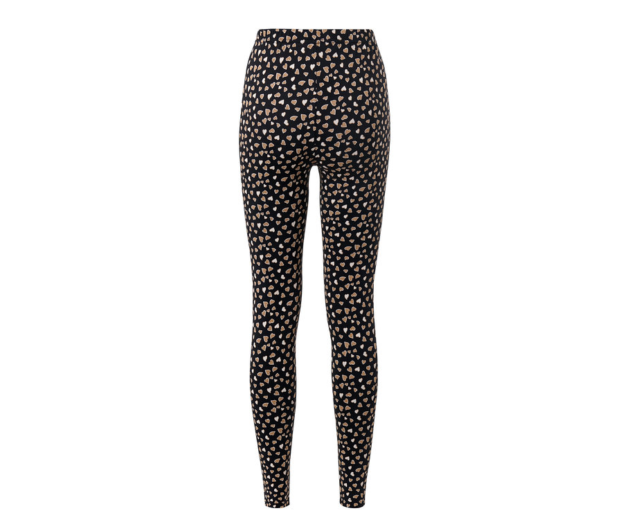 Legging noir à motif intégral de coeurs.