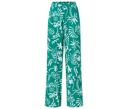 Pantalon vert ample avec motif blanc.