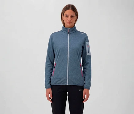 Femme portant un pantalon noir et une veste CMP pour femme bleue avec fermeture éclair et poches.