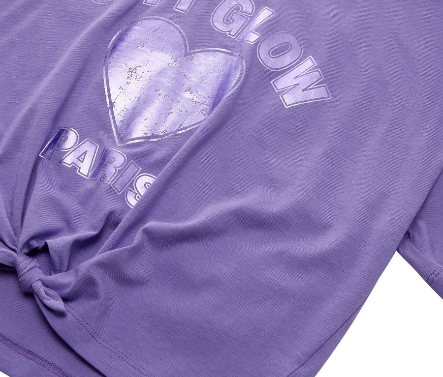 Gros plan d'un t-shirt violet Tom Tailor avec l'inscription CITY GLOW PARIS et un motif de cœur.
