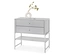 Commode grise à deux tiroirs et une étagère, sur laquelle repose un vase blanc avec des plantes.