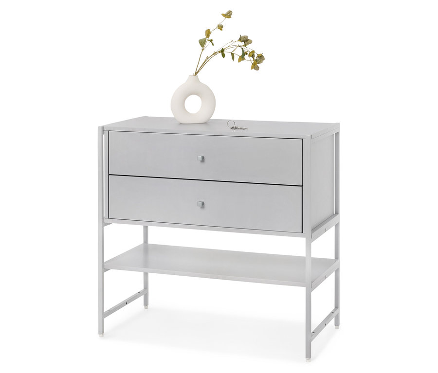 Commode grise à deux tiroirs et une étagère, sur laquelle repose un vase blanc avec des plantes.