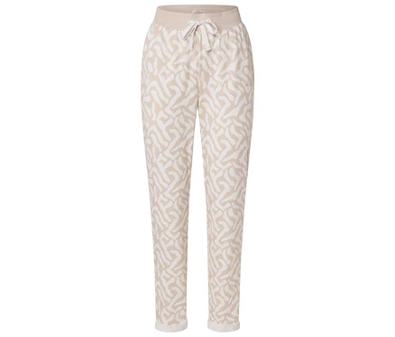 Pantalon beige à motifs abstraits blancs et cordon de serrage à la taille.