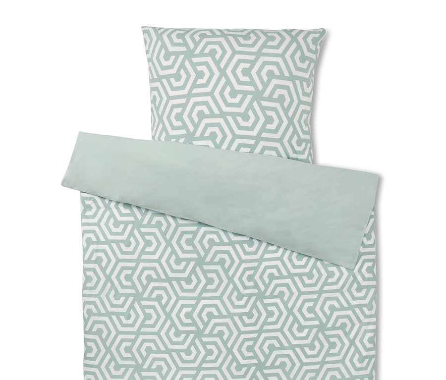 Ensemble de literie avec motif géométrique en blanc et vert.