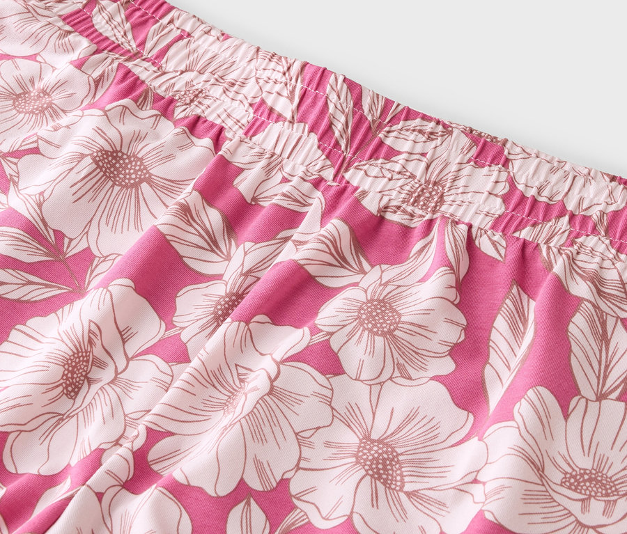 Gros plan sur un tissu rose à motifs floraux avec une taille élastique.