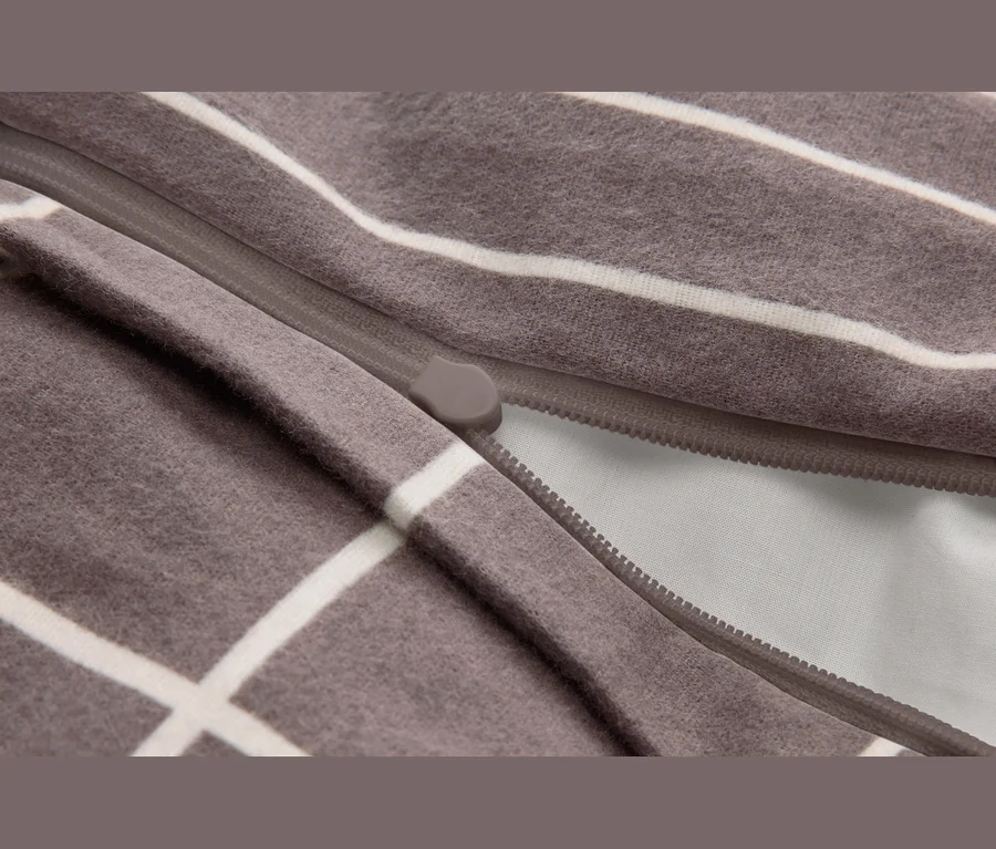 Tissu marron à rayures blanches avec une fermeture éclair partiellement ouverte.