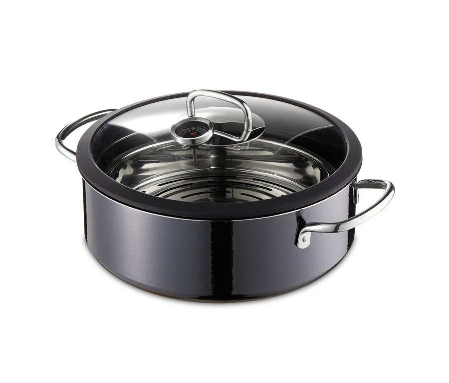 Un cuiseur vapeur Silit Ecompact Professional noir et rond avec un couvercle transparent.