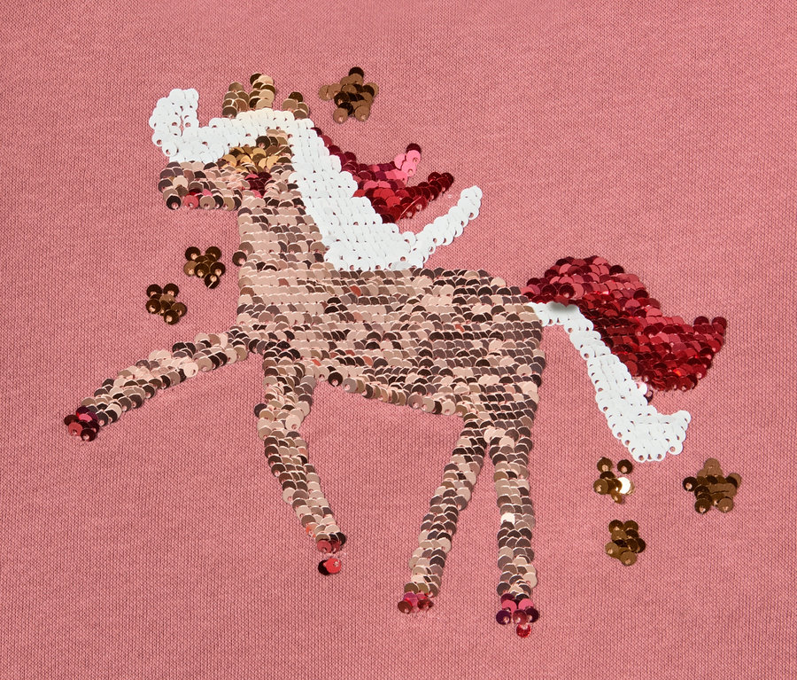 Tissu rose avec motif de licorne en paillettes réversibles ou imprimé.
