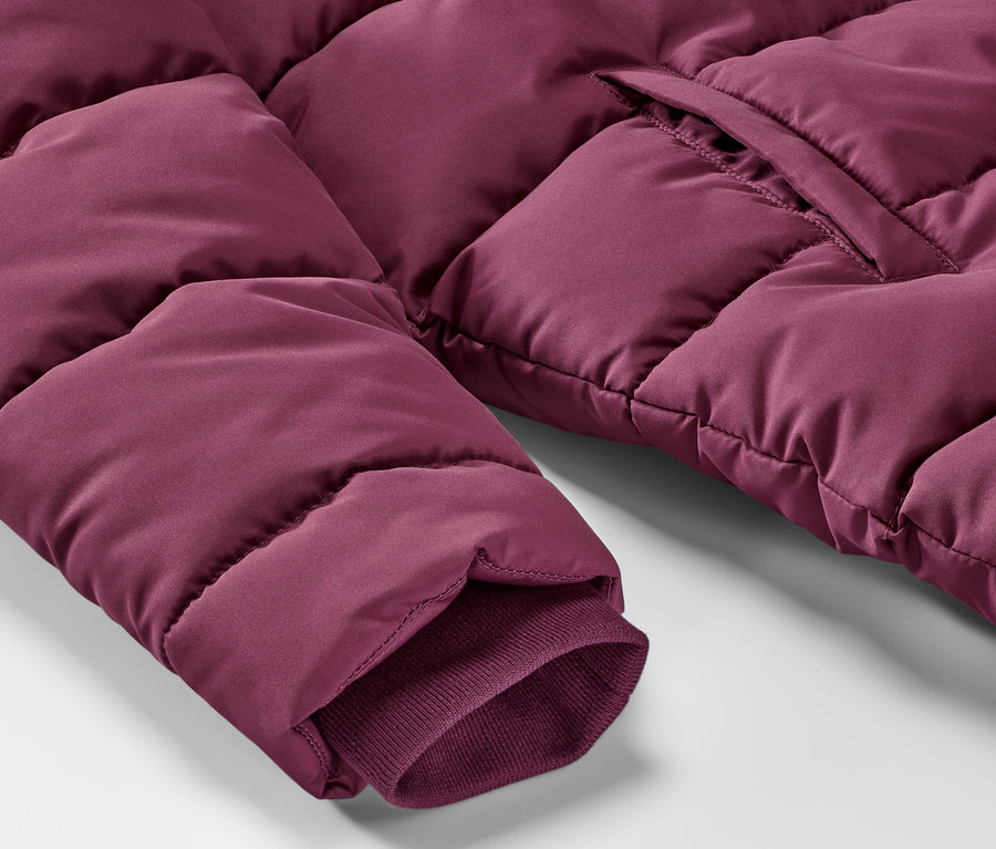 Gros plan sur un manteau thermique pour enfant rouge et violet.