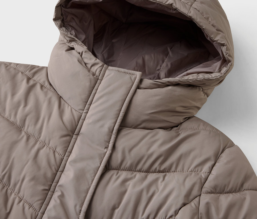 Détail d'une doudoune beige avec capuche.
