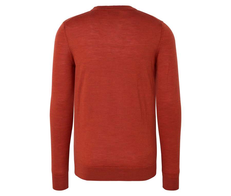 Gros plan d'un pull en laine mérinos chiné orange.