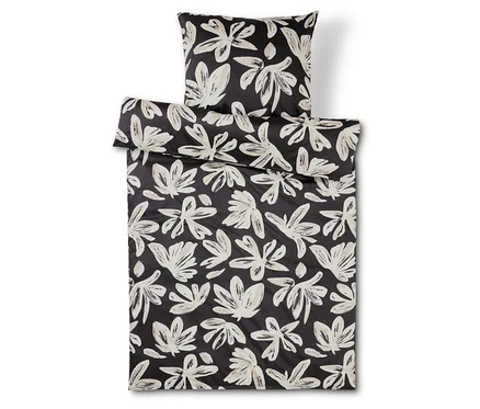 Literie et oreiller à fleurs noir et blanc.