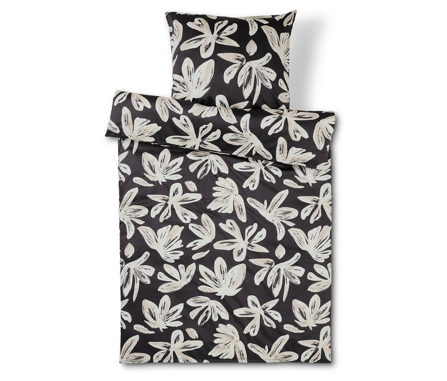Literie et oreiller à fleurs noir et blanc.