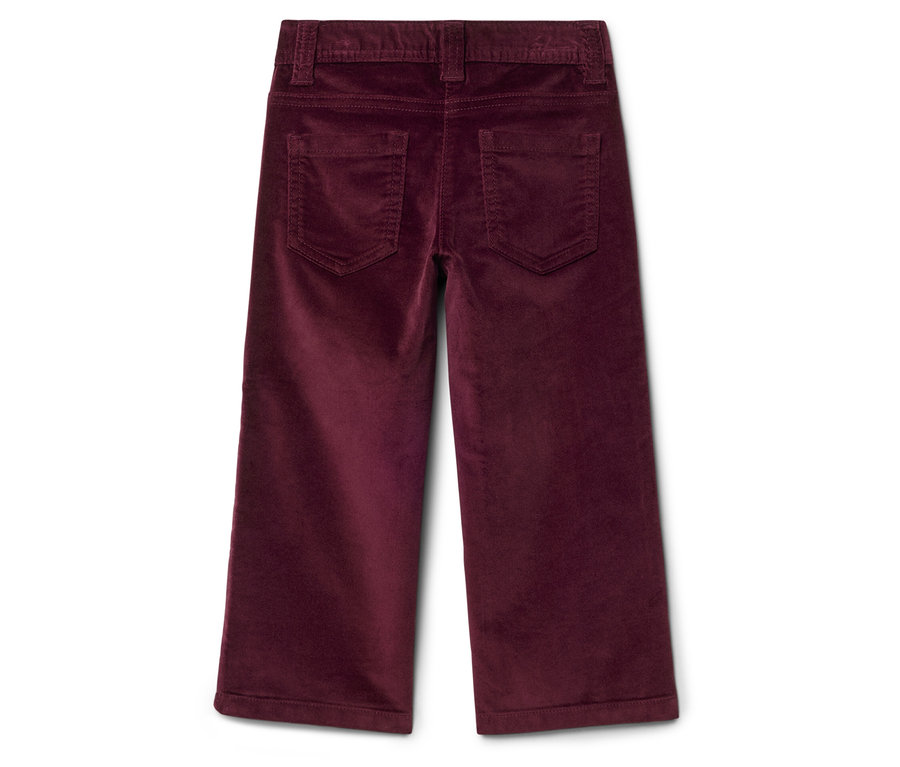 Détail de l'arrière d'un pantalon en velours côtelé bordeaux.
