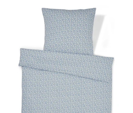 Linge de lit à motif floral et oreiller.