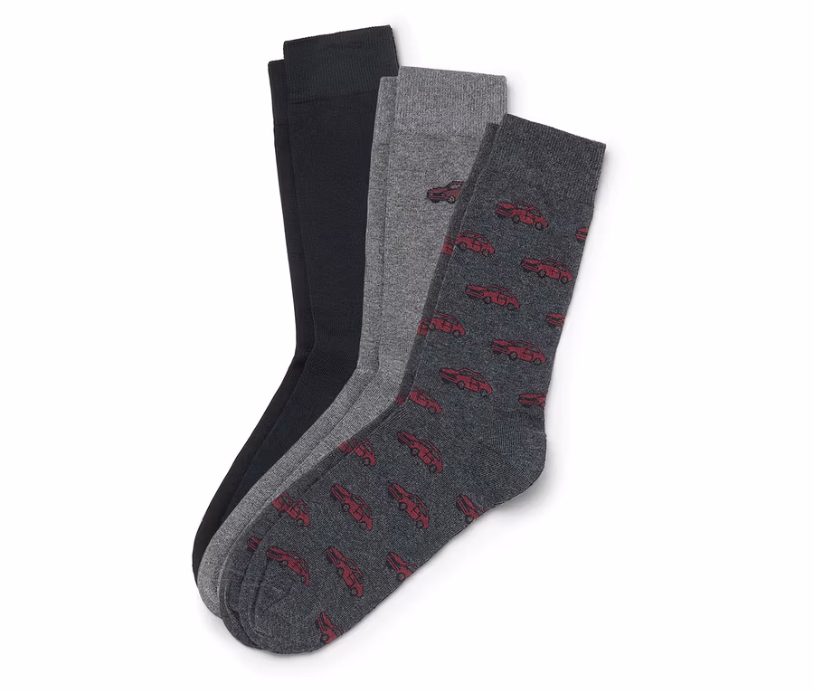 Trois chaussettes sont superposées : une noire, une grise et une gris foncé avec des voitures rouges.