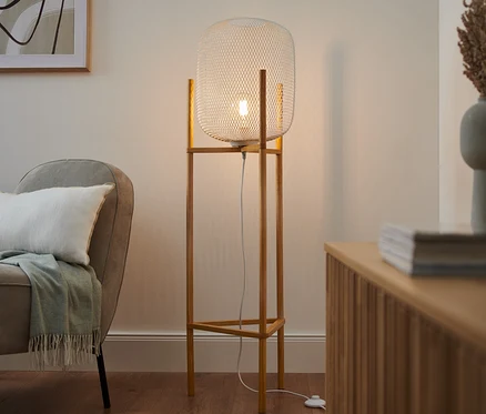 Un lampadaire trépied dans un salon.