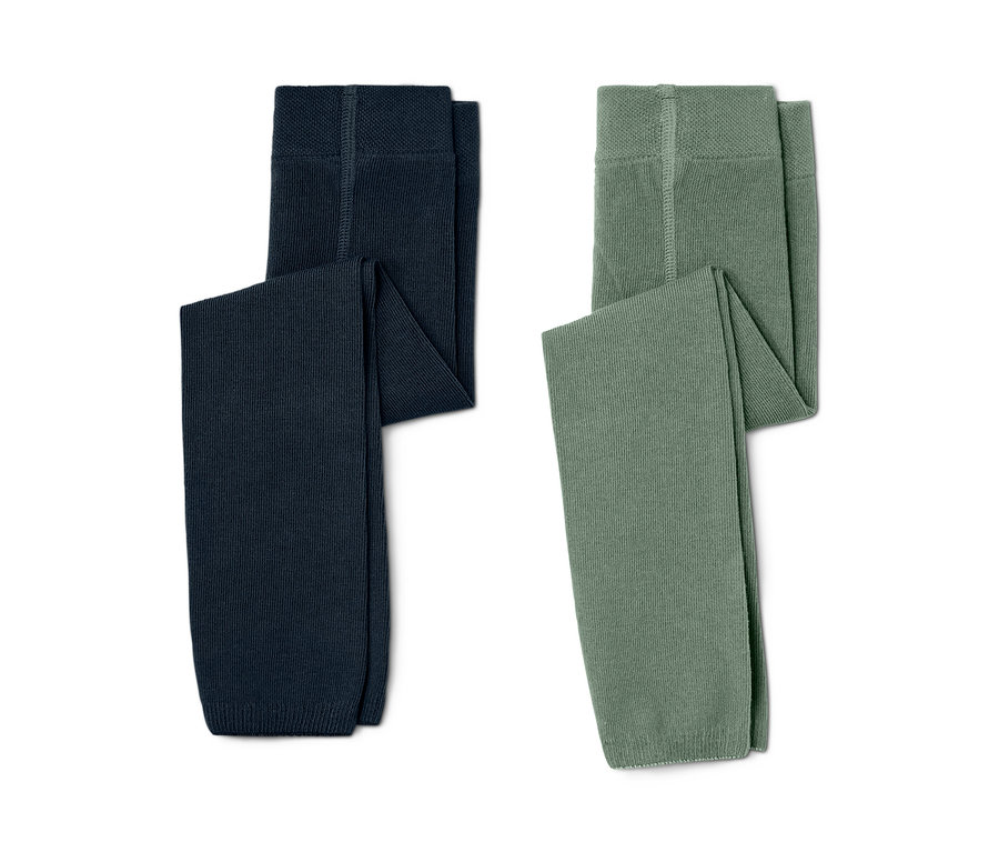 Deux leggings en maille pour enfant, un bleu marine et un vert, sont posés côte à côte sur un fond blanc.