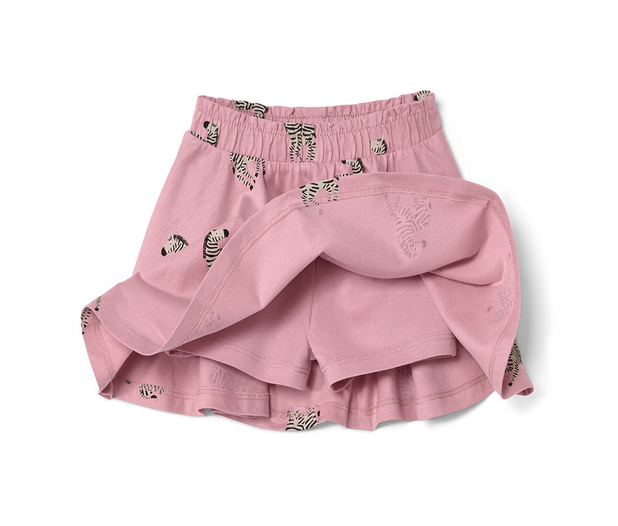Gros plan sur une jupe en jersey avec pantalon pour enfant rose à motif zébré.