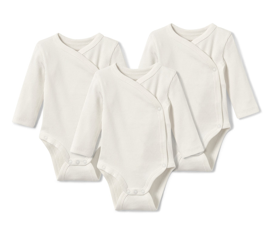 Trois bodys côtelés manches longues pour bébé blancs.