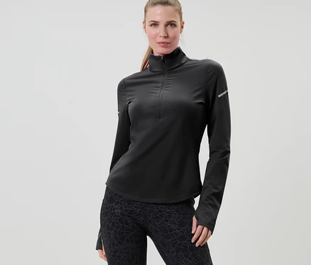 Femme posant en t-shirt technique thermique noir.