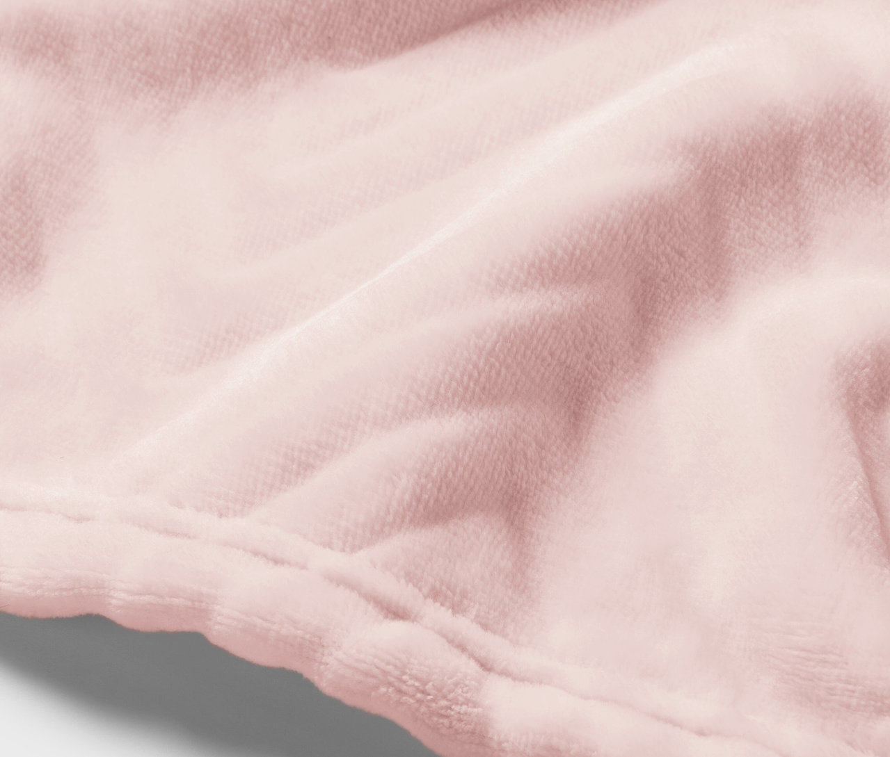 Gros plan sur un tissu de velours rose avec une couture.