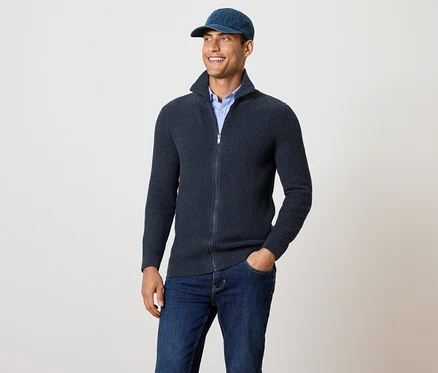 Un homme porte une veste en maille bleu marine chiné.