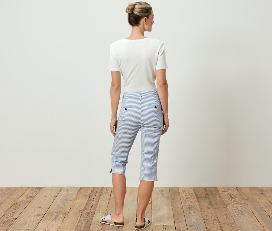 Femme vue de dos portant un t-shirt blanc et un pantalon en sergé stretch 3/4 à rayures bleues.