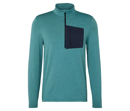 Haut turquoise chiné à manches longues avec fermeture éclair courte et poche bleu foncé sur la poitrine gauche.