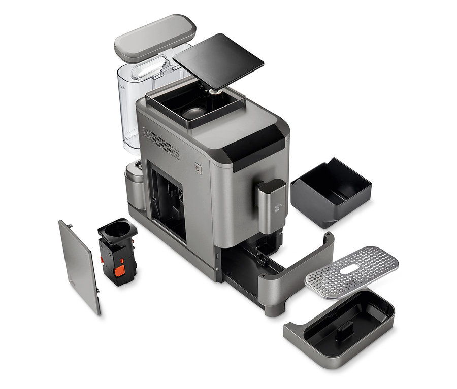 Machine à café entièrement automatique « Esperto2 Caffè » Titanium Silver partiellement démontée avec différentes pièces détachées.