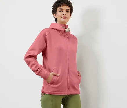 Femme posant dans une veste à capuche rose.