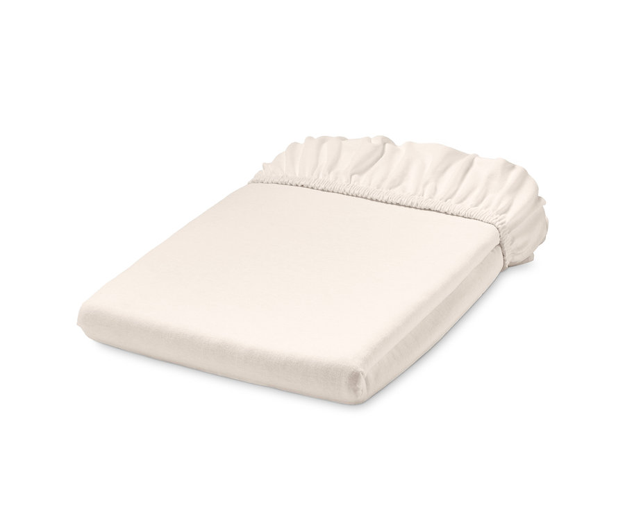 Drap-housse en jersey blanc de taille standard plié.