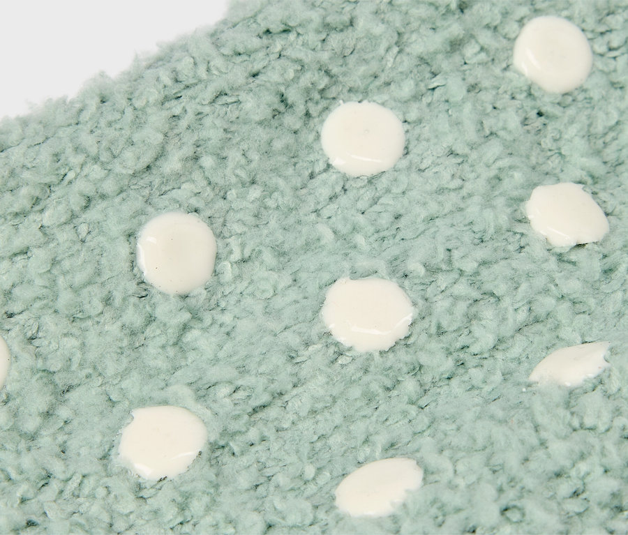 Gros plan d'un tissu bleu clair avec des pois blancs.