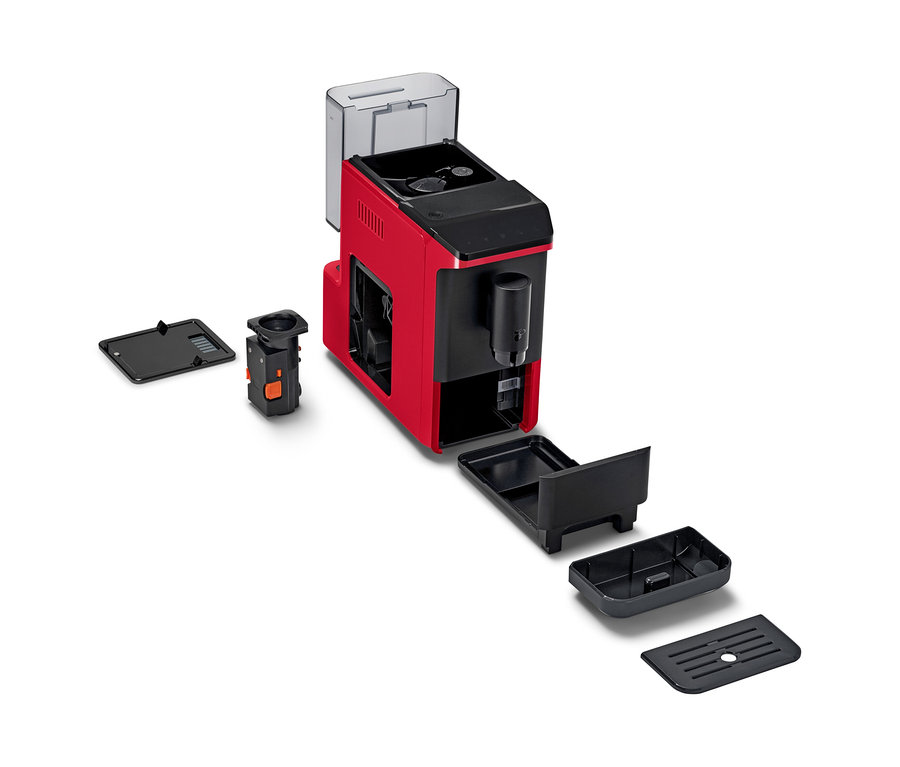 Une machine à café entièrement automatique « Esperto mini » rouge et noire est présentée démontée, avec son réservoir d'eau transparent, son unité de percolation noire et ses composants de bac d'égouttement noirs sur fond blanc.