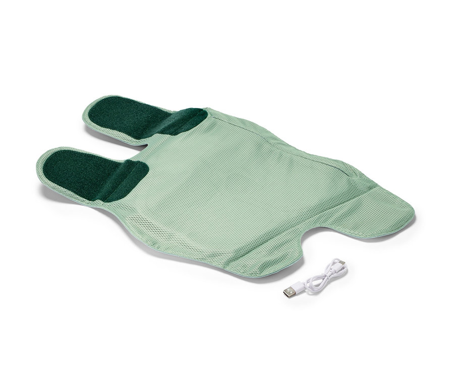 Une manchette de massage sans fil vert clair avec un câble de charge.