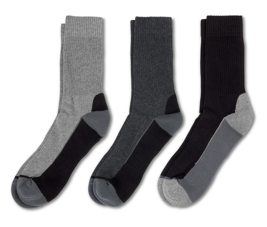 Trois paires de chaussettes : gris clair, gris foncé et noir, toutes avec des talons et des orteils noirs.