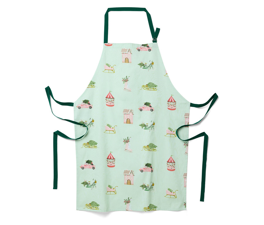 Tablier vert clair avec un motif de Noël de maisons, voitures, traîneaux et carrousels.