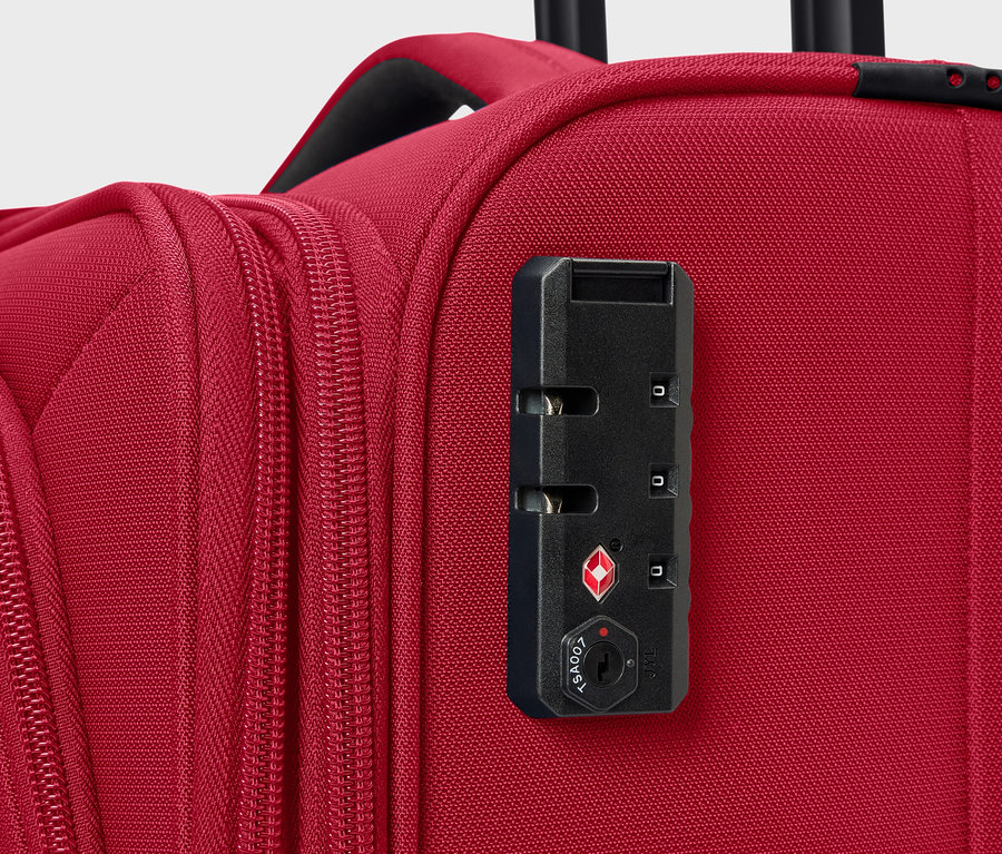 Gros plan d'une valise rouge avec une serrure à combinaison.
