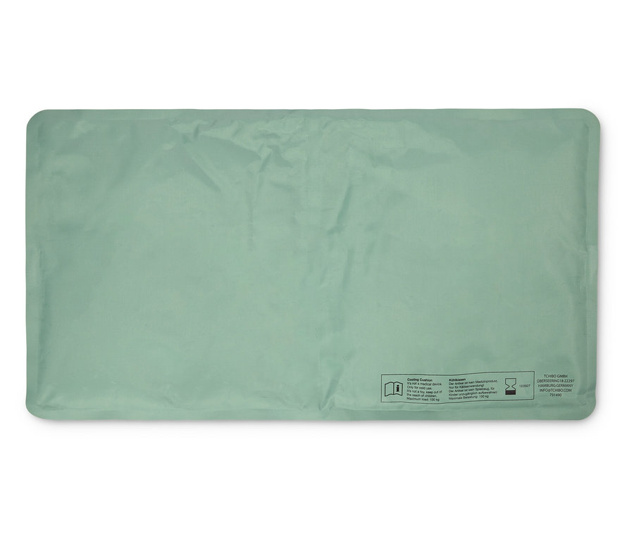 Coussin réfrigérant vert clair, rectangulaire et posé à plat.