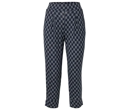 Pantalon bleu marine avec motif géométrique blanc.