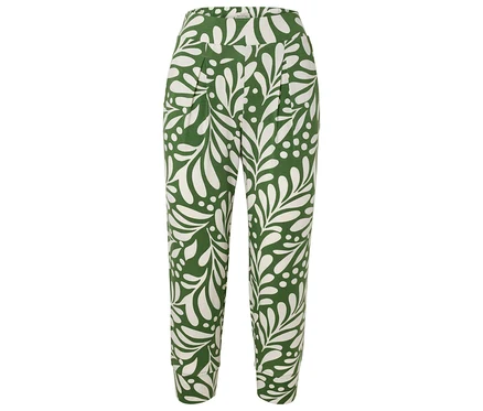 Pantalon vert avec motif de feuilles blanches.