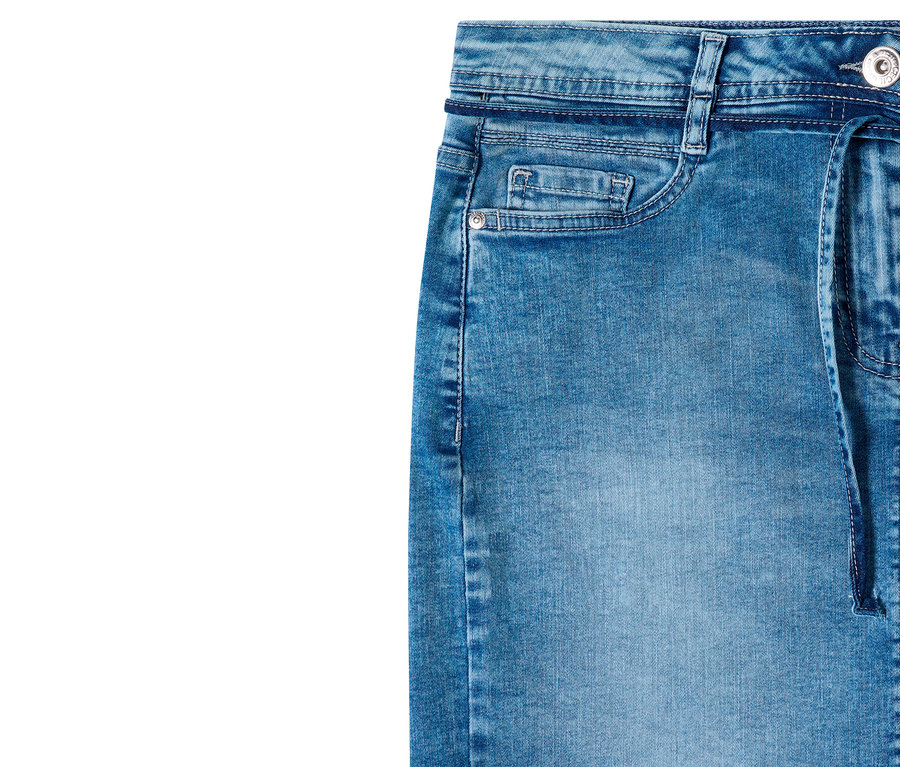Gros plan d'une jupe en jean CECIL bleue délavée, montrant la ceinture avec des passants, une petite poche à monnaie, une poche incurvée plus grande avec un rivet argenté et un lien en jean pendant du côté droit.