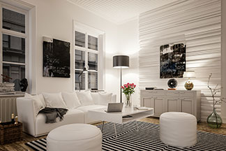 Lampe de salon comme accroche-regard : un salon meublé en noir et blanc avec un canapé blanc, des coussins d’assise ronds blancs et un lampadaire avec un abat-jour noir.